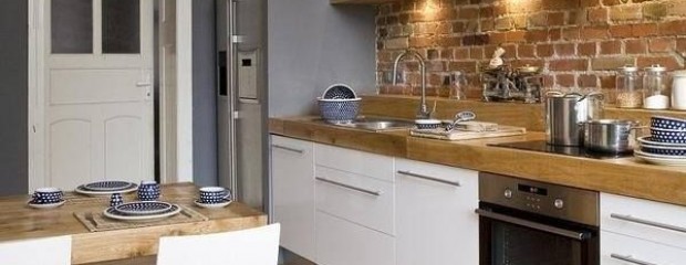 grey kitchen with exposed brick